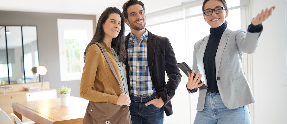 An agent showing a house, depicting a real estate agent presenting a property for sale or viewing.