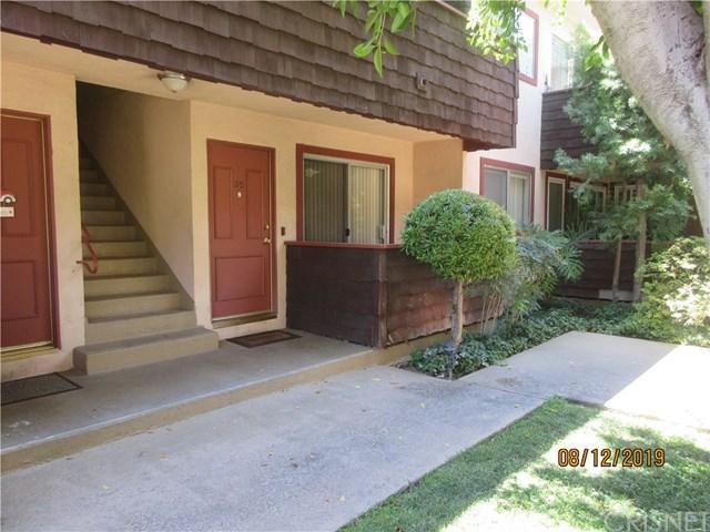 RHB Assets From IGX: Elegant Los Angeles house with a beautiful facade and palm trees in front.