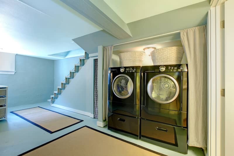 RHB Assets From IGX: Basement laundry room with modern appliances and ample storage.