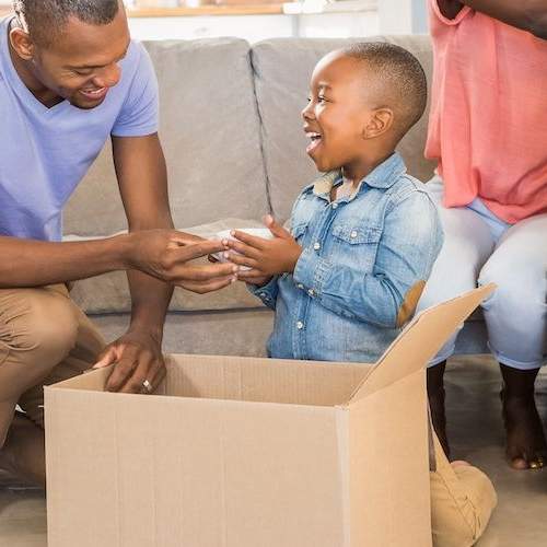A family happily unpacking boxes in their new home, creating a welcoming atmosphere.