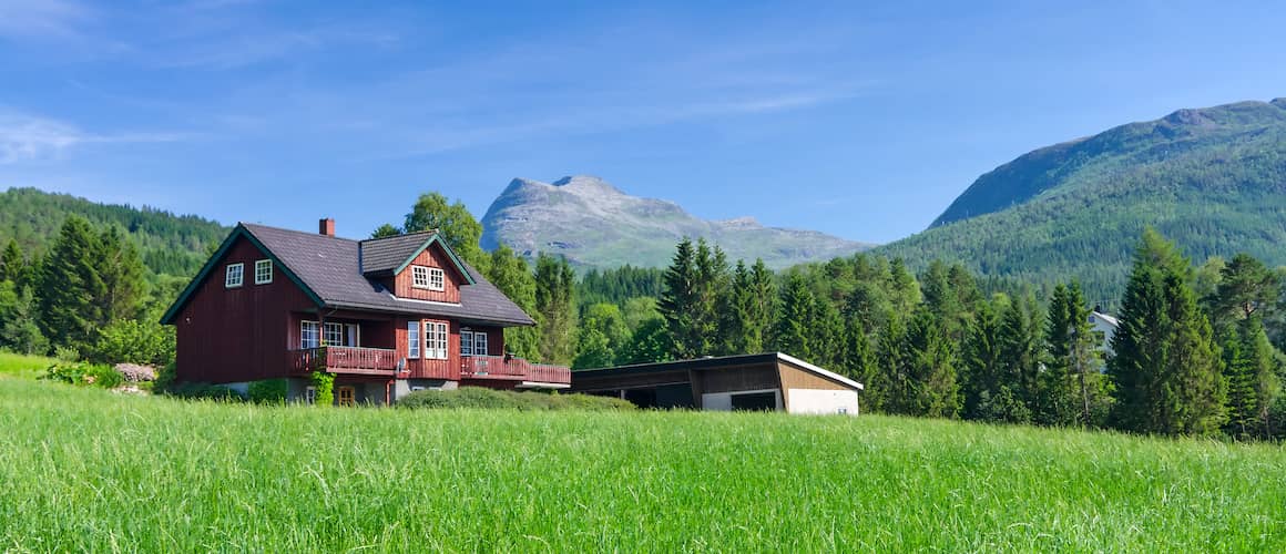 Bard red house in mountains.