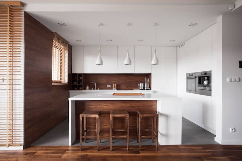 Kitchen with wood slatted backsplash and wood accent wall.