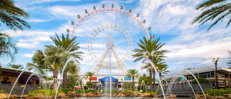 RHB Assets From IGX: A breathtaking view of the Orlando Eye Ferris wheel against a vibrant blue sky.