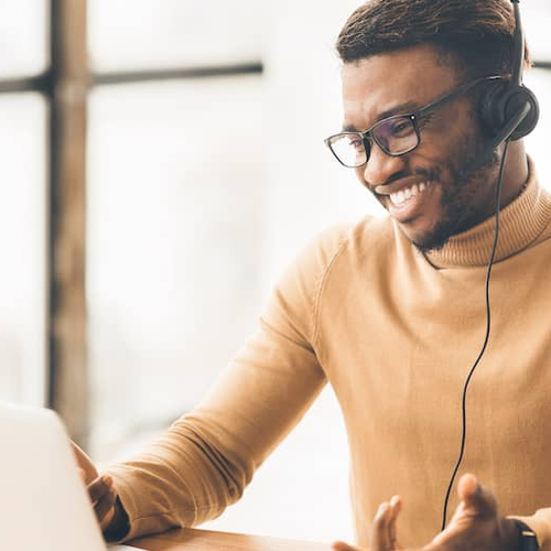 A man wearing a headset, likely in a customer service or financial services role.