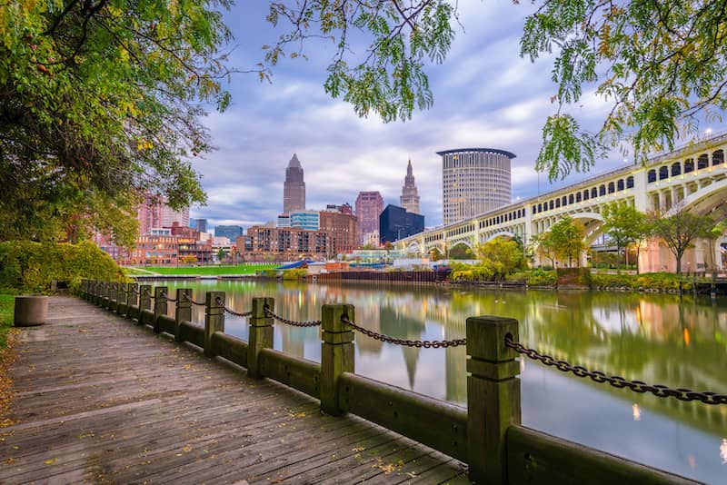 RHB Assets From IGX: View of Cleveland, Ohio skyline from across the river with buildings reflecting on the water.