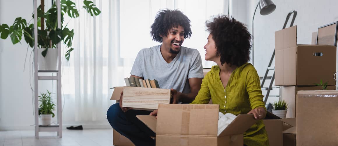 RHB Assets From IGX: African-American couple unpacking boxes in their new home