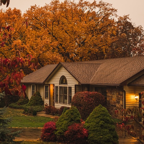 House in Missouri in autumn, surrounded by richly-colored foliage.