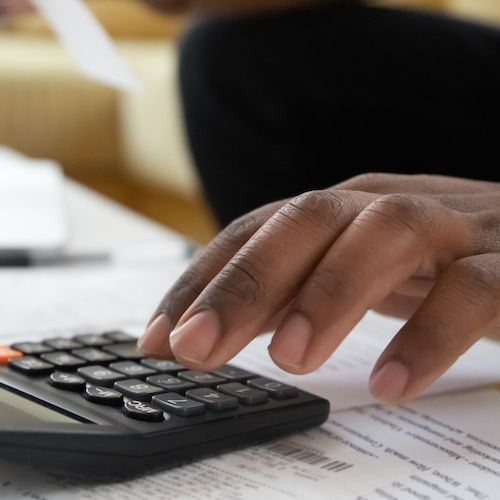 Calculating mortgage payments, representing financial planning or budgeting.