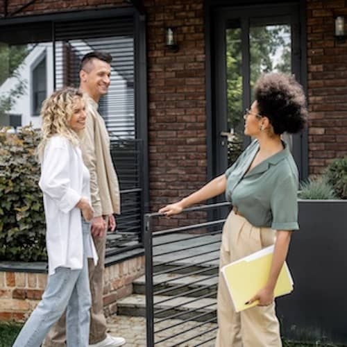 Realtor showing couple a property.