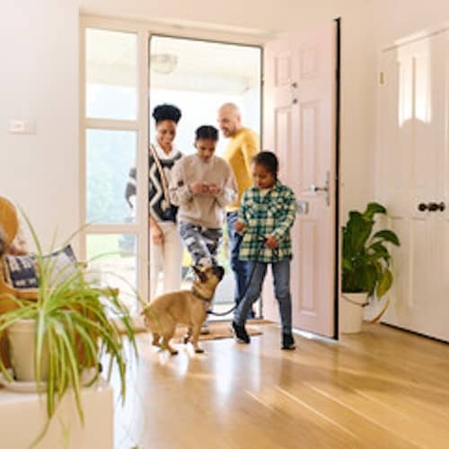 Family returning home from walking their dog.