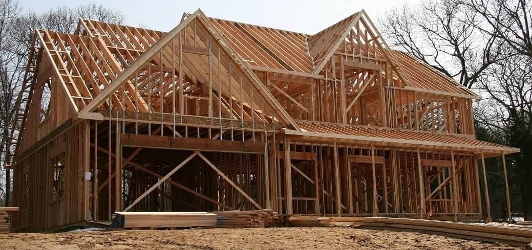 Construction workers building the frame of a new home.