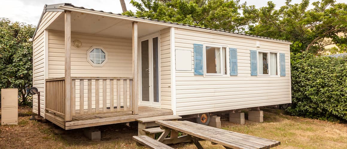 Stock image displaying a mobile home at a camping site, showcasing vacation living or mobile home lifestyle.