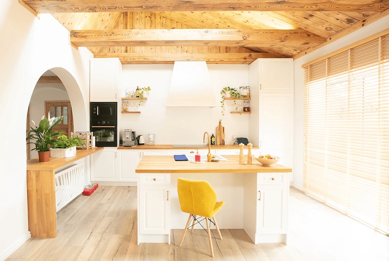 RHB Assets From IGX: Rustic kitchen with a beamed ceiling and modern appliances.