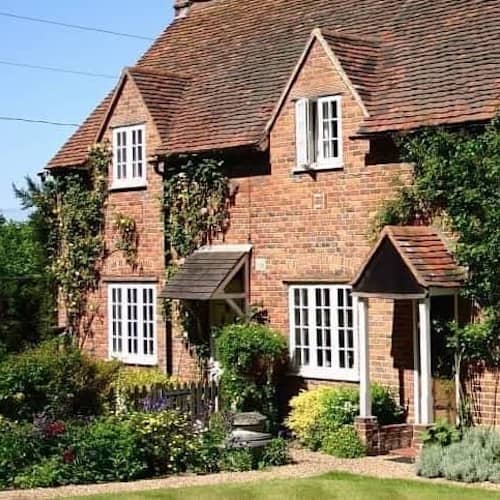 A vintage cottage-style brick home, highlighting its nostalgic and traditional appearance.