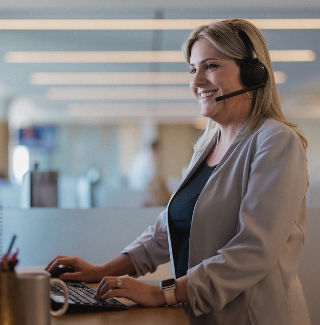 A Rocket Mortgage home loan expert wearing a headset helps a client review their mortgage.