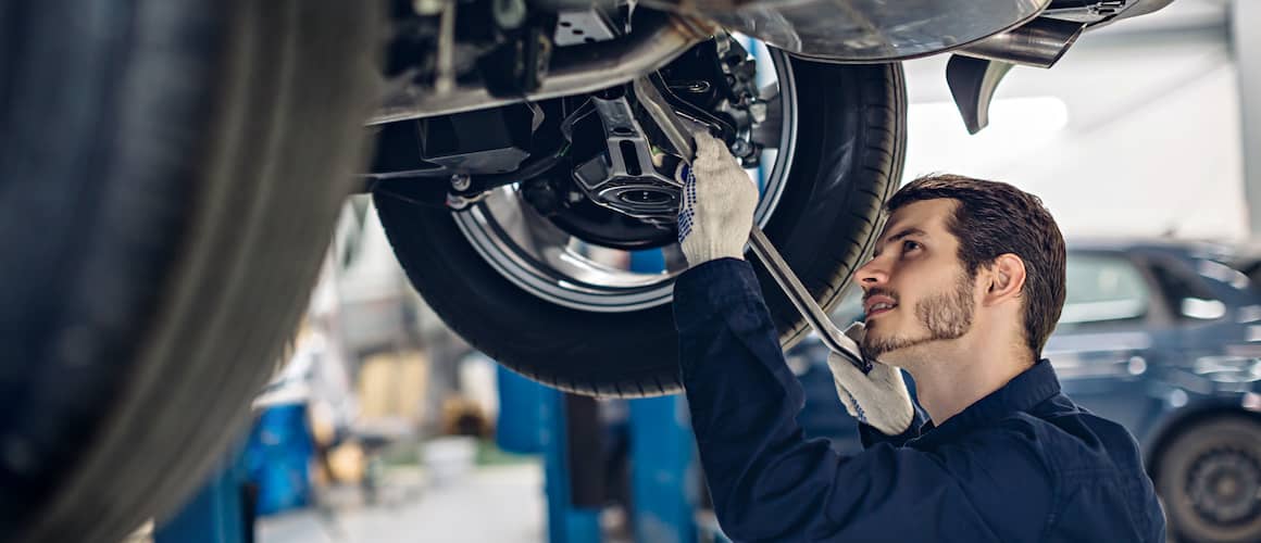 man underneath car repairing