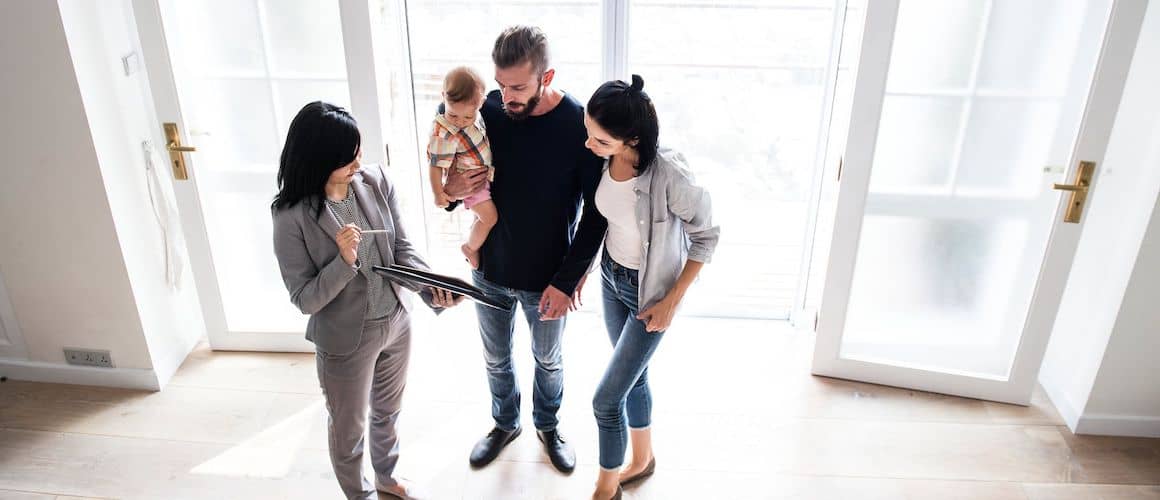 RHB Assets From IGX: Family asking a real estate agent about the home-buying process in a staged living room.