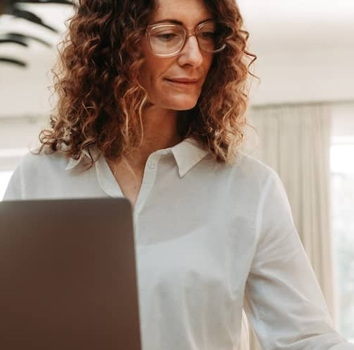 Woman going over paperwork and having coffee.