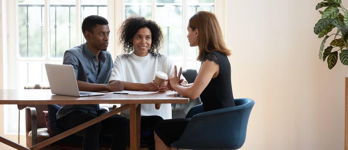 A couple planning a real estate transaction, possibly discussing property options or mortgage plans.