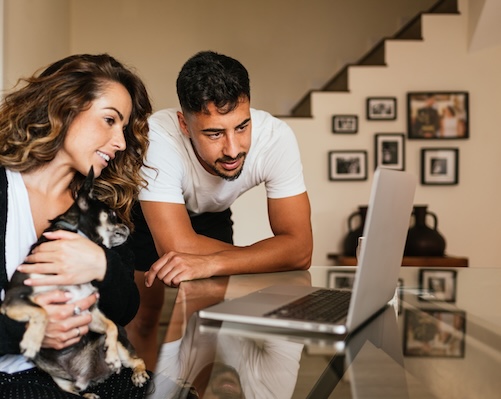 Couple looking at homes online.