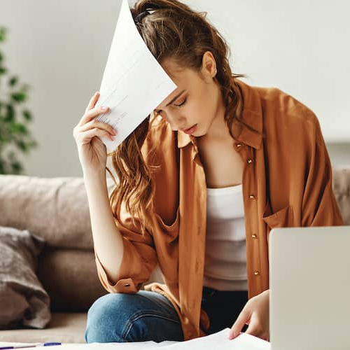 A woman managing bills or finances, possibly organizing payments or budgeting.