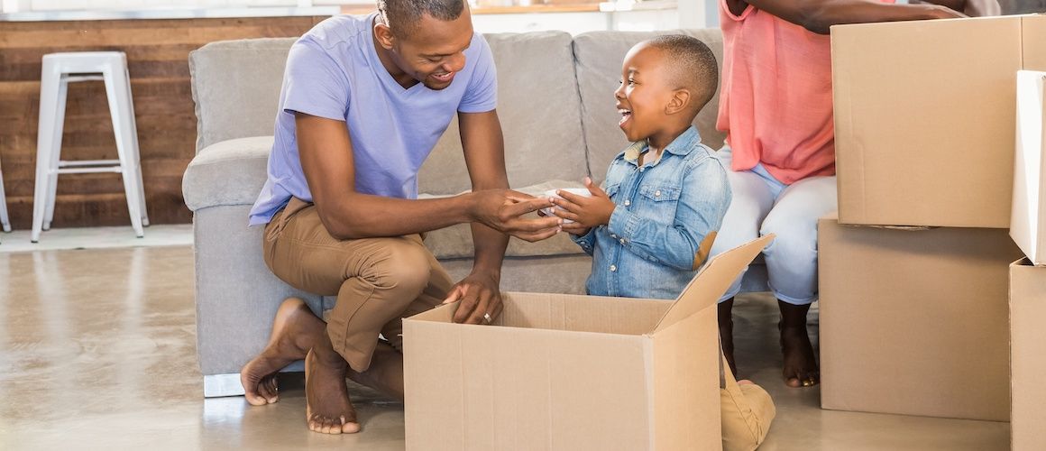 A family happily unpacking boxes in their new home, creating a welcoming atmosphere.