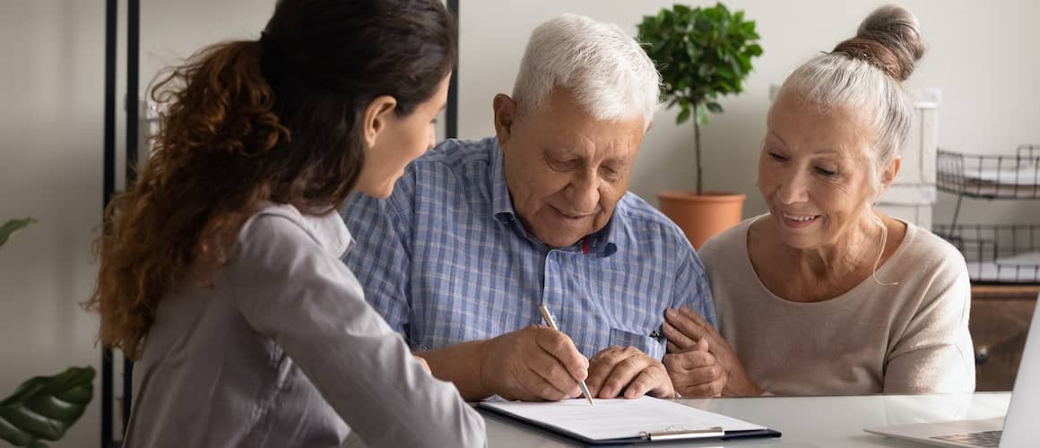 RHB Assets From IGX: An elderly couple signing over their home to a young woman.