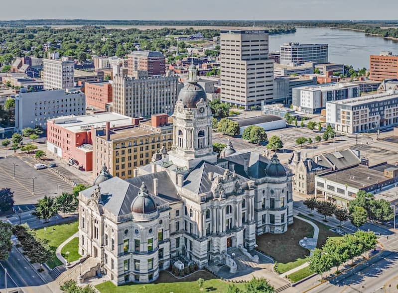 RHB Assets From IGX: Aerial view of Vandenburgh Courthouse surrounded by greenery.