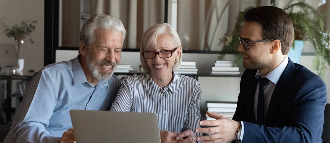 RHB Assets From IGX: Senior couple discussing with a real estate agent in a living room