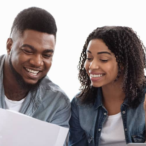Happy couple discussing something on papers.