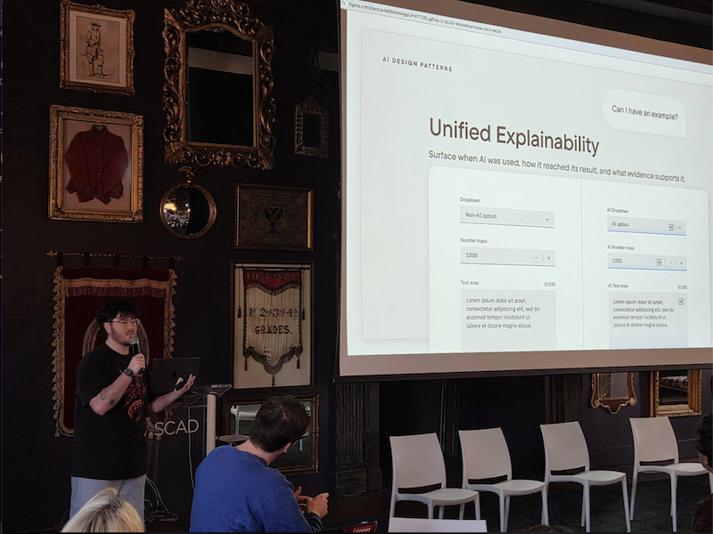 Team member presenting in front of screen.