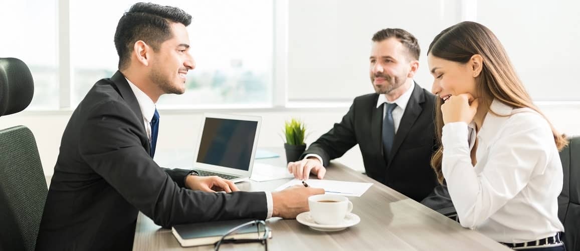 A banker discussing a loan with a couple.