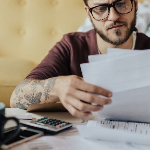 A man looking at finances, possibly related to financial planning or reviewing financial data.