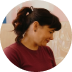 Small portrait of a women with brown hair smiling.