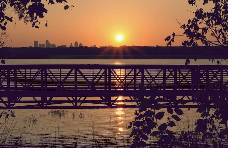 Sunset over a bridge and lake with background buildings in Texas