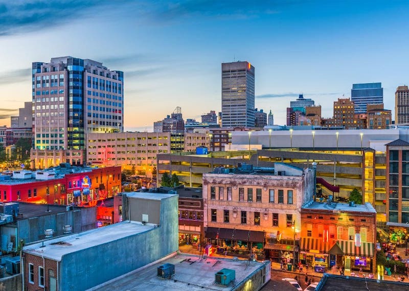 View of lit up buildings at sunset in a downtown in Shelby County.