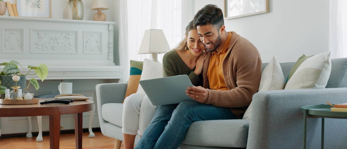 Couple looking at computer together.