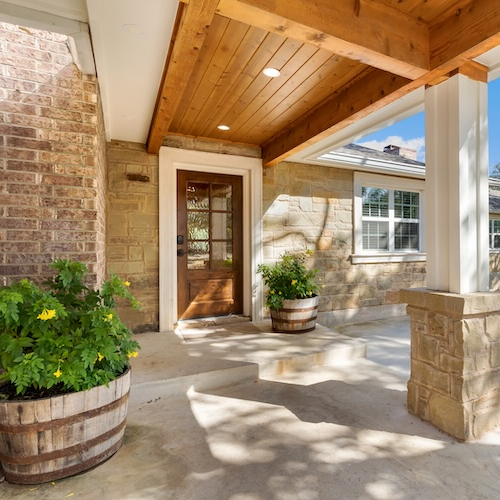 Front porch with potted plants of large home in Alabama.