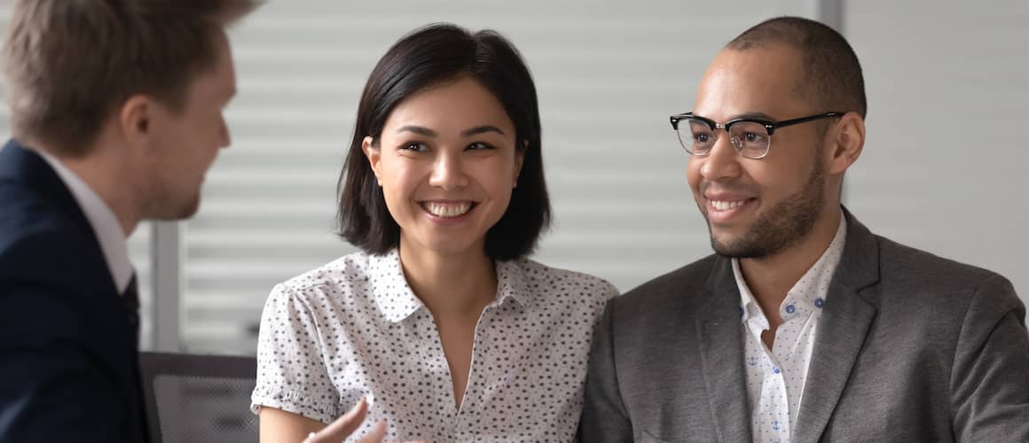 RHB Assets From IGX: Realtor consulting with a young couple during a home tour.