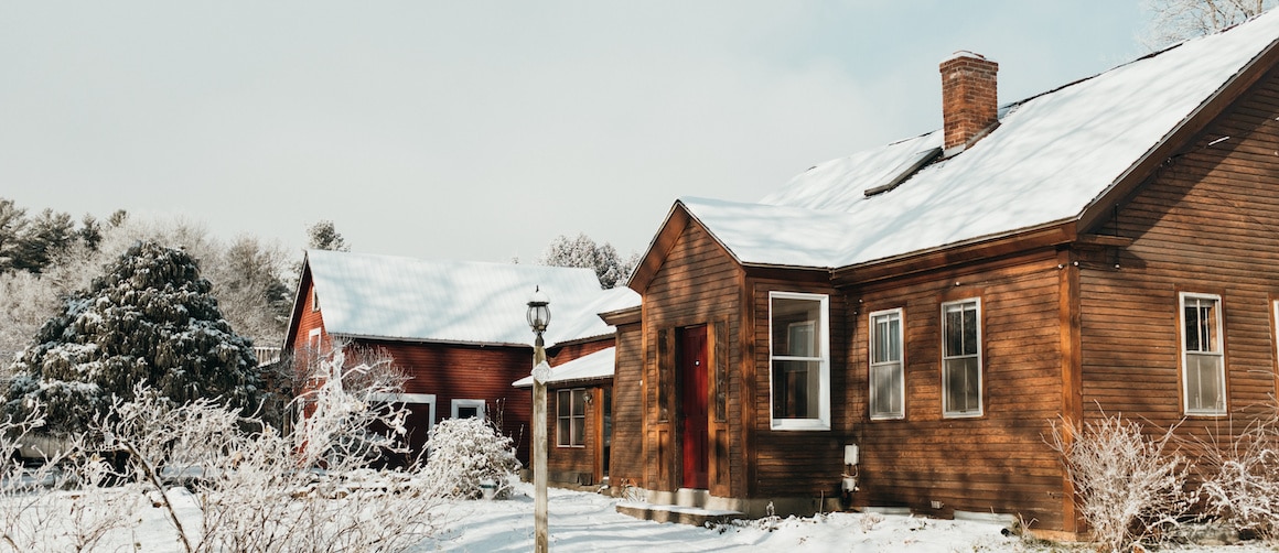 RHB Assets From IGX: A house and barn in Cape Cod during winter with snow on the ground.