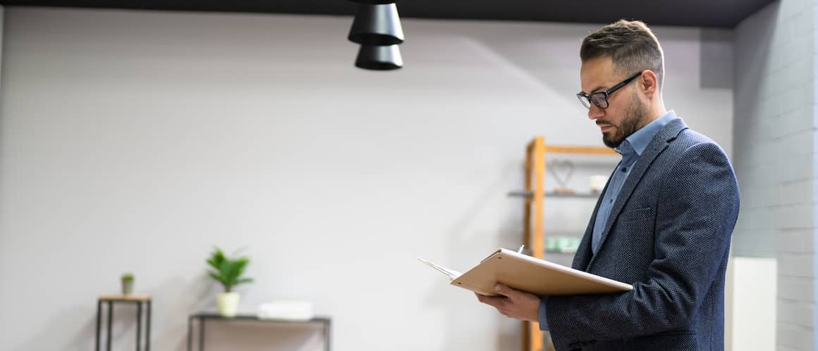 A professional appraiser meticulously inspects a property, examining its features and documenting findings.