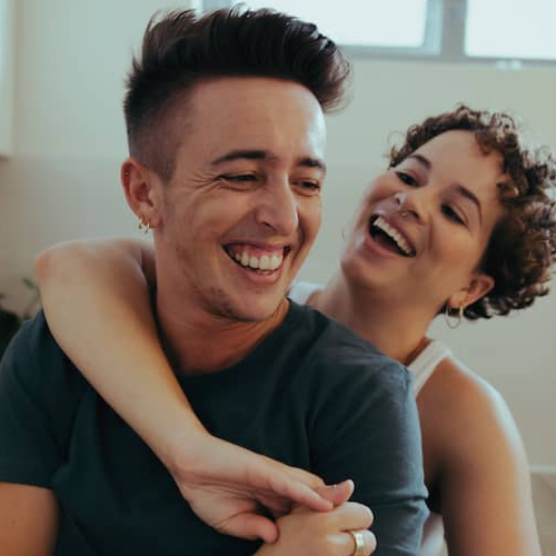 Happy couple standing in a new modern kitchen.