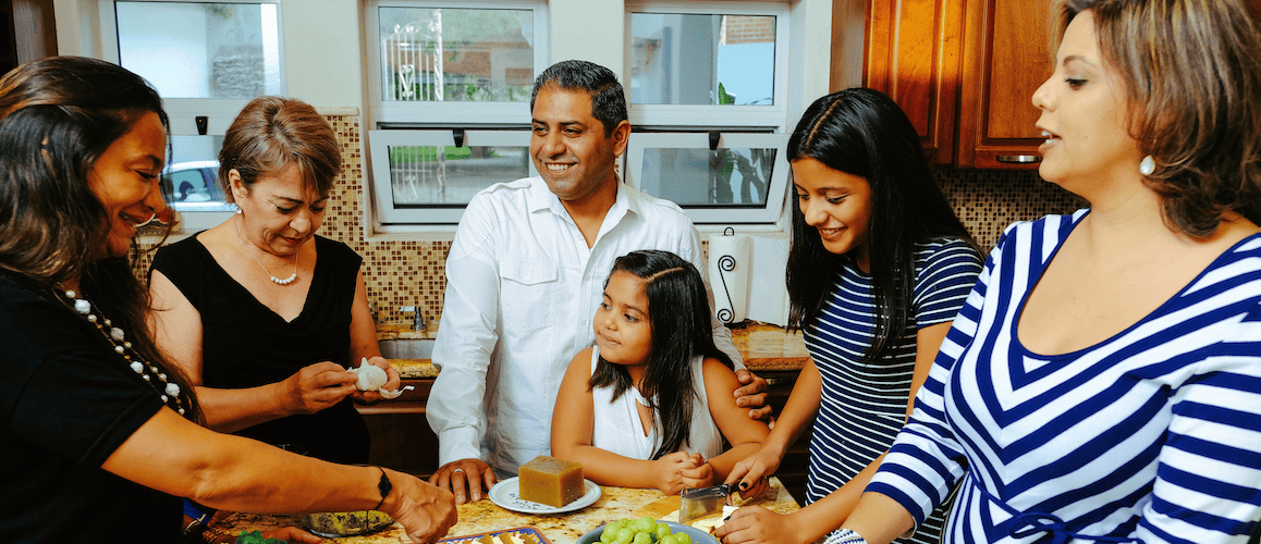 Family in the kitchen preparing a meal together.