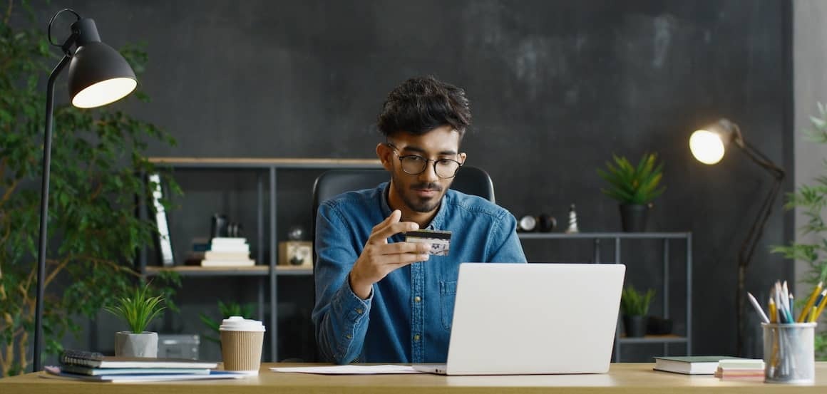 Stock-Guy-Reading-Credit-Card-AdobeStock-352340174 copy.jpeg