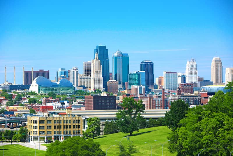 RHB Assets From IGX: Kansas City skyline during daytime with cloud-streaked blue sky