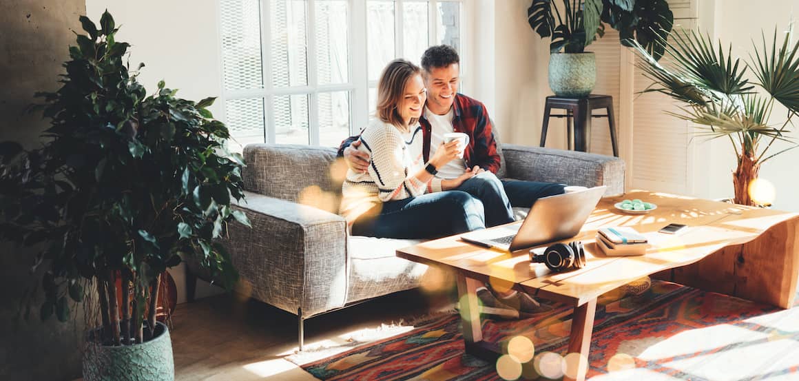 RHB Assets From IGX: A couple watching a laptop on a sofa