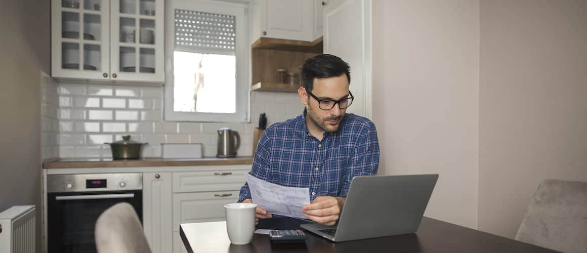 An accountant working from home, possibly related to financial aspects of mortgages or real estate.