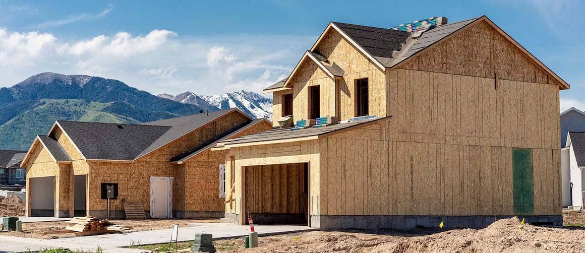 An under construction wooden house in mountains possibly depicting an area for buying a real estate property such as a second vacation home.