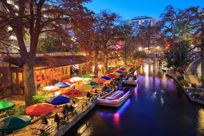 River walk in San Antonio, Texas, with colorful lights.