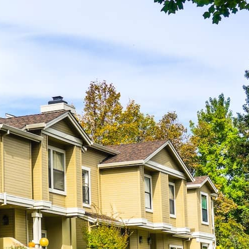 Yellow and white multifamily home.